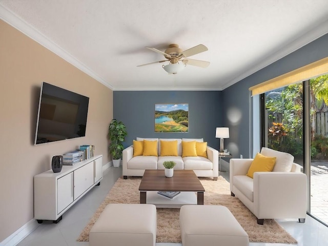 living area with crown molding, a wealth of natural light, ceiling fan, and baseboards