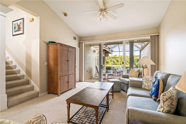 living room featuring decorative columns, vaulted ceiling, light carpet, and ceiling fan