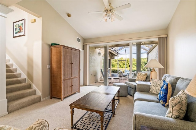 living room with high vaulted ceiling, light colored carpet, and ceiling fan