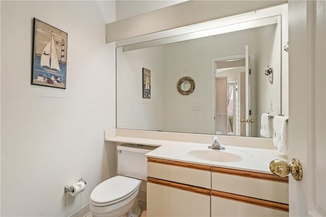 bathroom featuring vanity and toilet