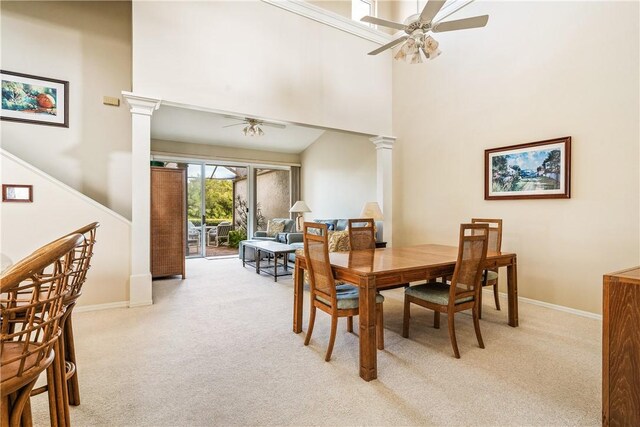 carpeted living room with ceiling fan and high vaulted ceiling