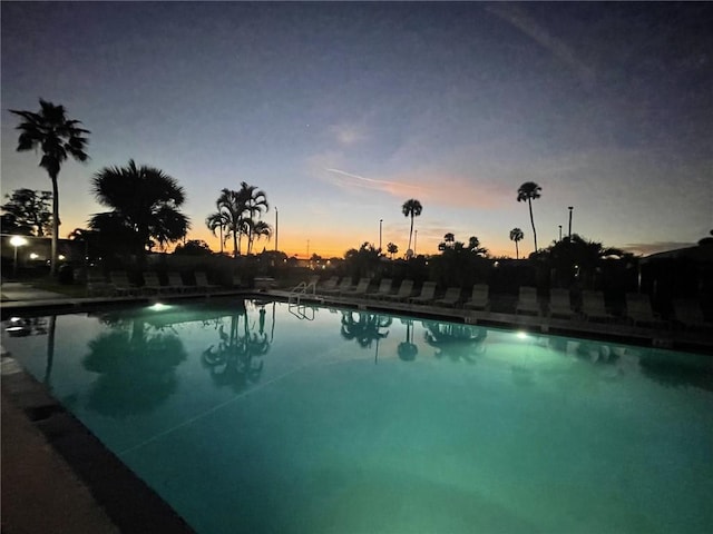 view of pool at dusk