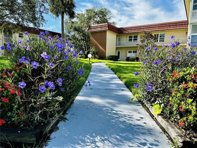 view of home's community with a yard