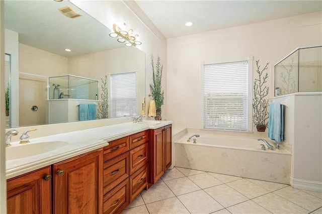 bathroom with a garden tub, a sink, visible vents, and a shower stall