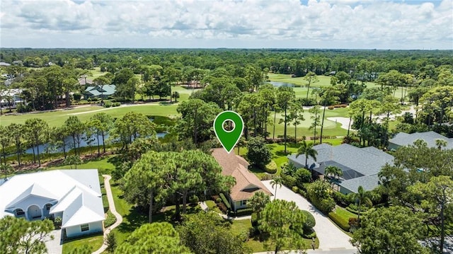 birds eye view of property featuring a water view, a wooded view, and a residential view