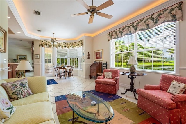 living area featuring a ceiling fan, visible vents, plenty of natural light, and light tile patterned floors