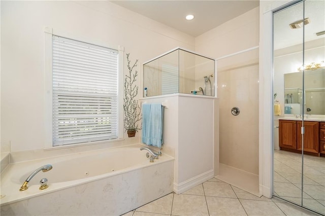 full bath with a stall shower, vanity, a bath, and tile patterned floors