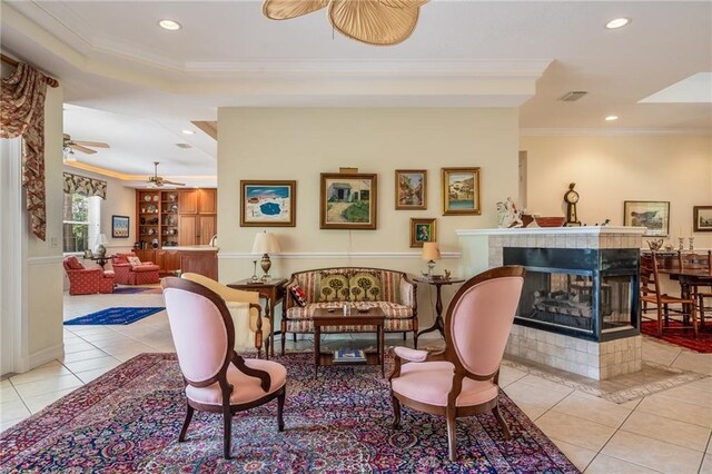 1156 Carolina Cir SW, Vero Beach, FL 32962 - sitting room featuring ceiling fan, tile patterned flooring, crown molding, recessed lighting, and a tile fireplace