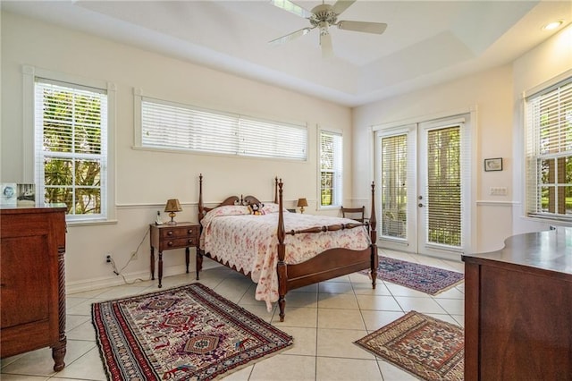 bedroom with light tile patterned floors, multiple windows, and access to exterior