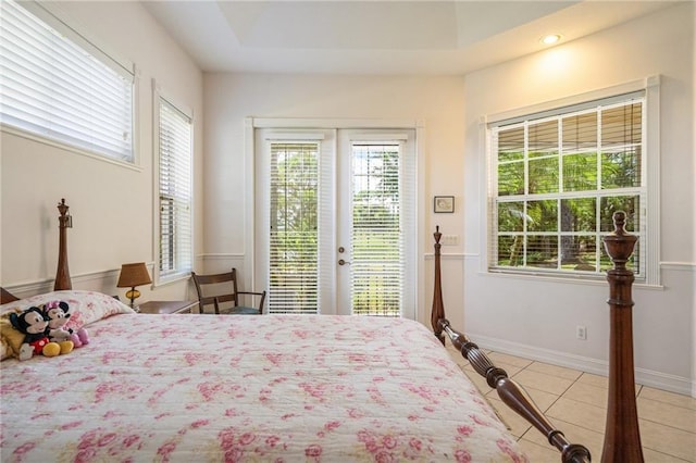 bedroom with light tile patterned floors, access to outside, french doors, and baseboards