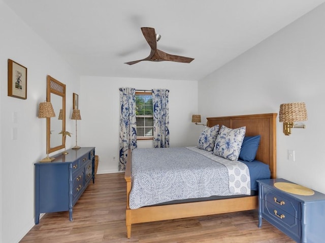 bedroom with ceiling fan and hardwood / wood-style floors