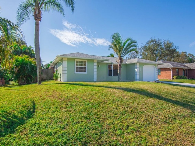 ranch-style house with a front yard and a garage