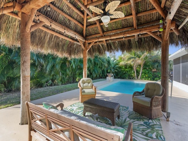 view of pool with ceiling fan, an outdoor hangout area, a gazebo, and a patio