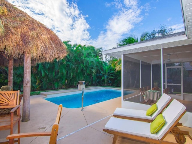 view of pool featuring a patio and a sunroom