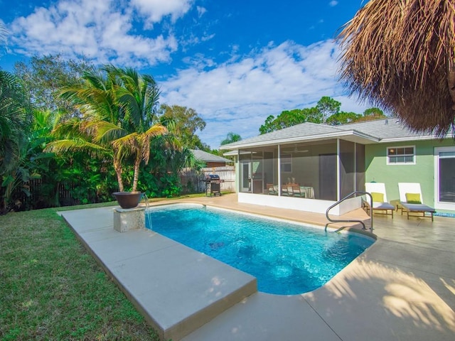 view of pool with a lawn, grilling area, a patio, and a sunroom