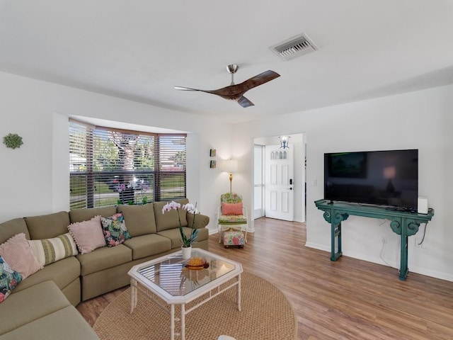 living room with light wood-type flooring and ceiling fan