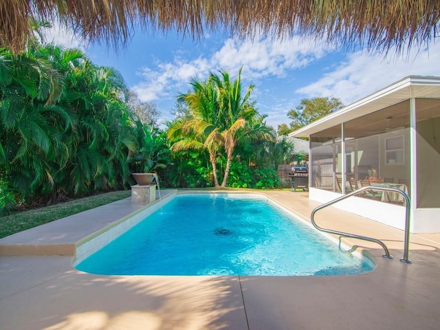 view of pool featuring a patio and a sunroom