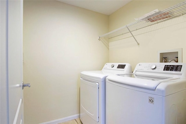5060 Fairways Cir Unit F312, Vero Beach, FL 32967 - laundry area featuring washing machine and dryer and baseboards