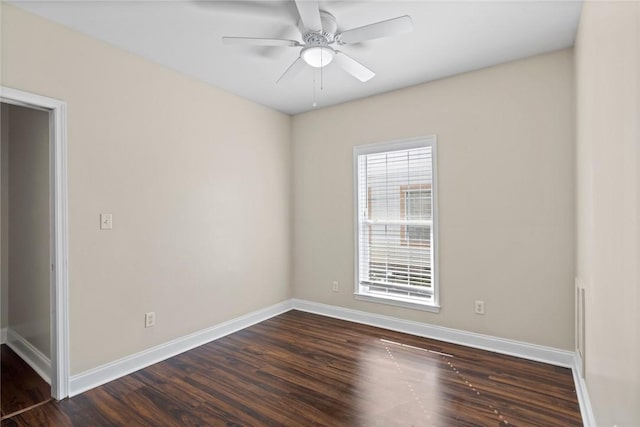 unfurnished room featuring baseboards, dark wood-type flooring, and a ceiling fan