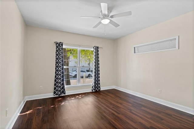 spare room featuring a ceiling fan, baseboards, and wood finished floors