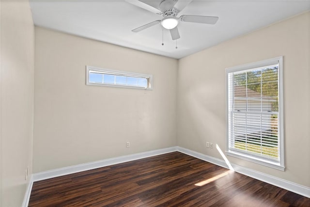 unfurnished room with dark wood finished floors, a healthy amount of sunlight, baseboards, and a ceiling fan