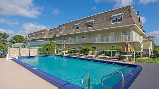 pool featuring a patio area and fence