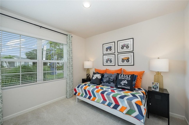 carpeted bedroom featuring baseboards