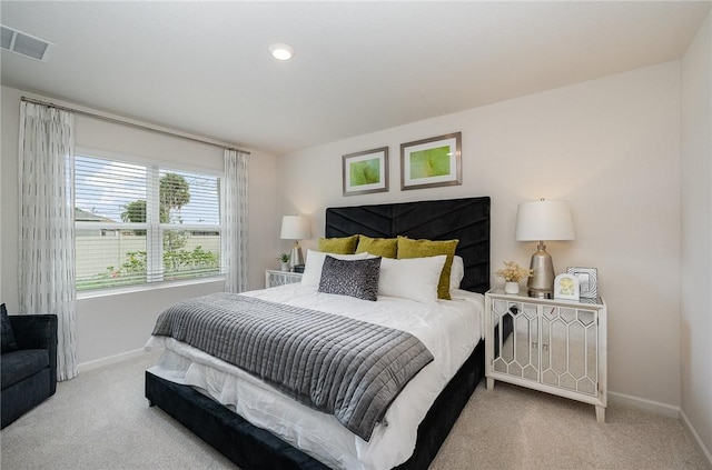 carpeted bedroom with baseboards and visible vents