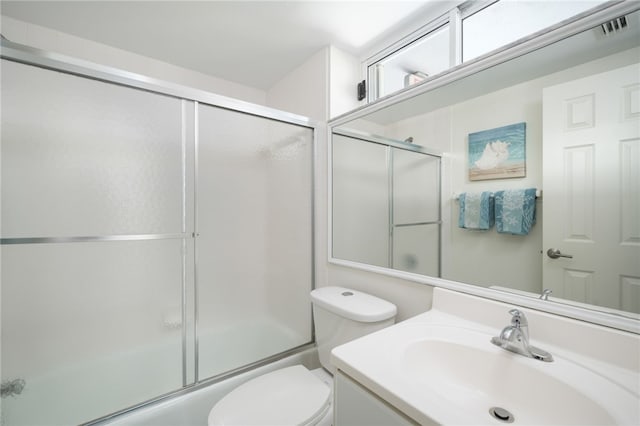 full bathroom with shower / bath combination with glass door, toilet, and vanity