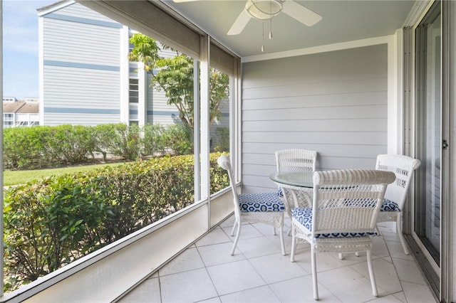 sunroom / solarium featuring ceiling fan