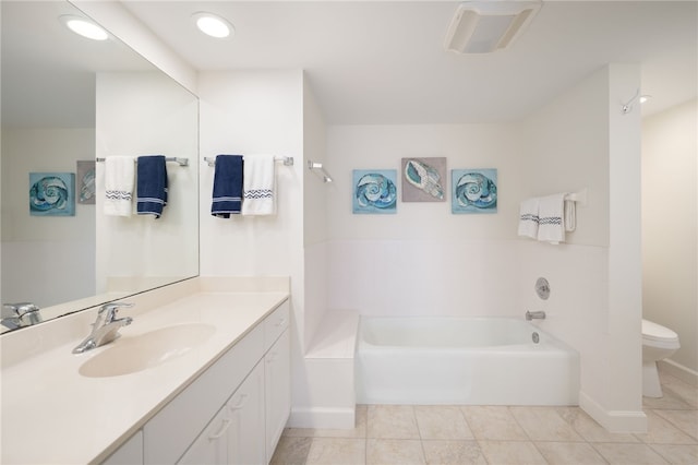 bathroom featuring toilet, vanity, a tub, and tile patterned floors