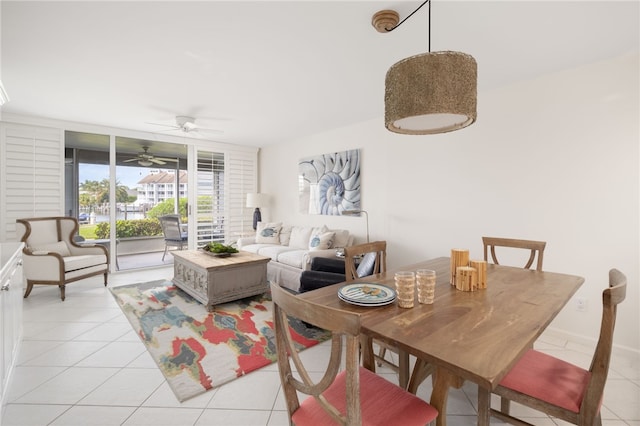 tiled dining space featuring ceiling fan