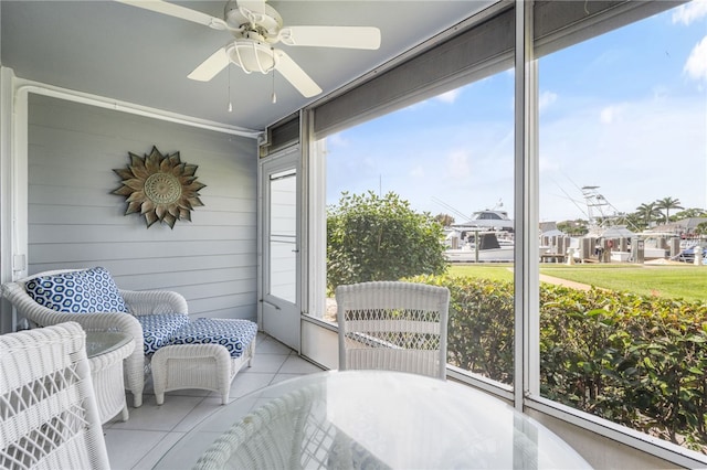 sunroom / solarium featuring ceiling fan and plenty of natural light