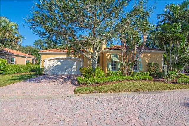 mediterranean / spanish home with a garage