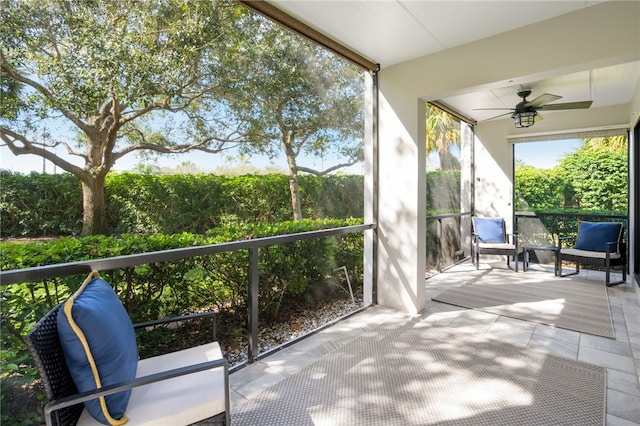 unfurnished sunroom featuring ceiling fan