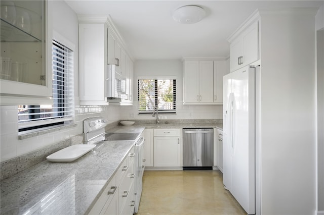 kitchen featuring sink, white appliances, light stone countertops, and white cabinets