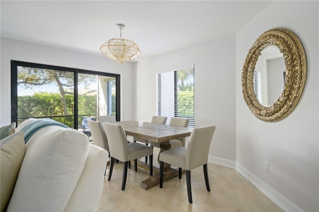 dining space with an inviting chandelier