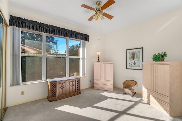 sitting room featuring ceiling fan and light carpet