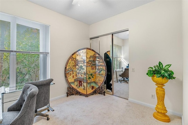 carpeted office featuring ceiling fan