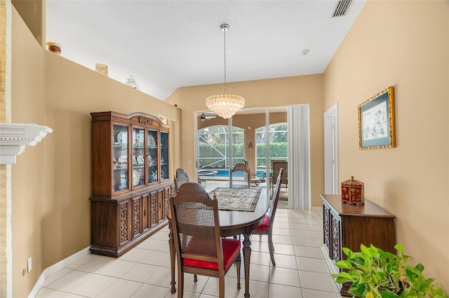 dining room with light tile patterned floors and a notable chandelier