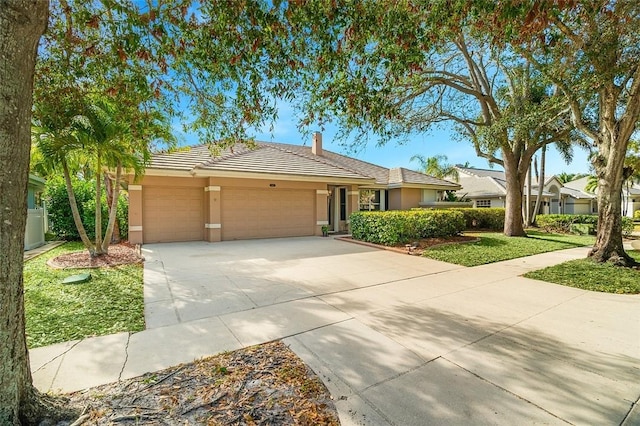 ranch-style home with a garage and a front lawn