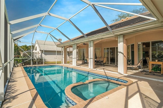 view of swimming pool featuring a lanai, a patio, ceiling fan, and a pool with connected hot tub