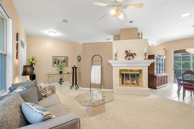 living room with ceiling fan, light tile patterned floors, and a fireplace