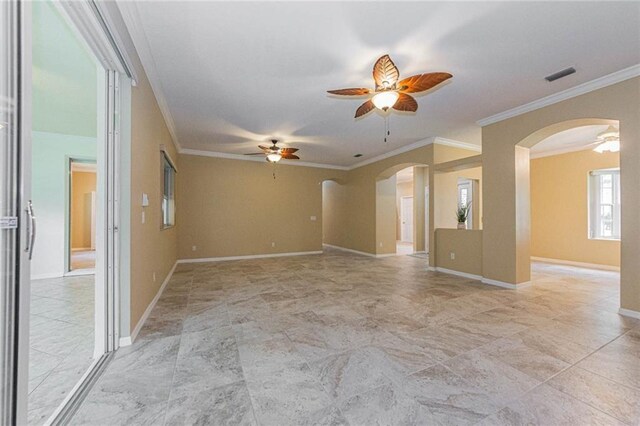 7941 Cabot Tower Pl, Vero Beach, FL 32966 - spare room featuring arched walkways, ceiling fan, ornamental molding, and baseboards