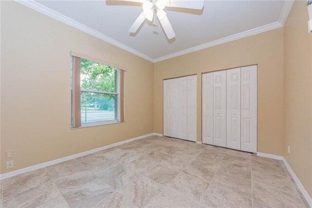 7941 Cabot Tower Pl, Vero Beach, FL 32966 - unfurnished bedroom with two closets, crown molding, baseboards, and a ceiling fan