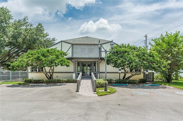 7941 Cabot Tower Pl, Vero Beach, FL 32966 - view of front of home with french doors, uncovered parking, and stucco siding
