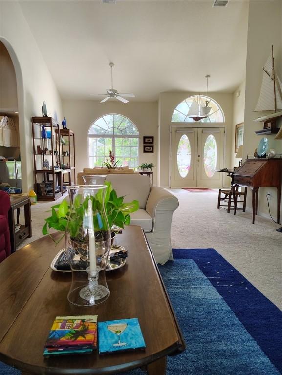 3932 58th Cir, Vero Beach, FL 32966 - dining space with arched walkways, carpet floors, ceiling fan, and lofted ceiling