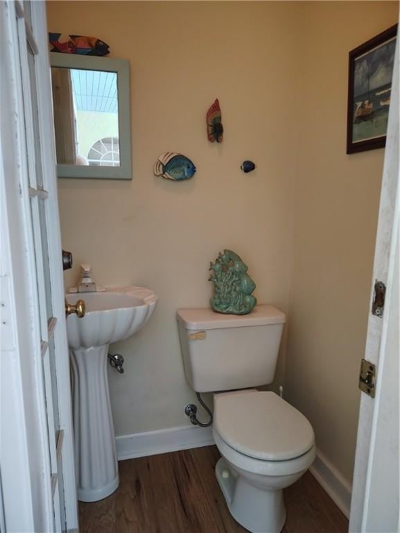 3932 58th Cir, Vero Beach, FL 32966 - bathroom featuring toilet, baseboards, and wood finished floors