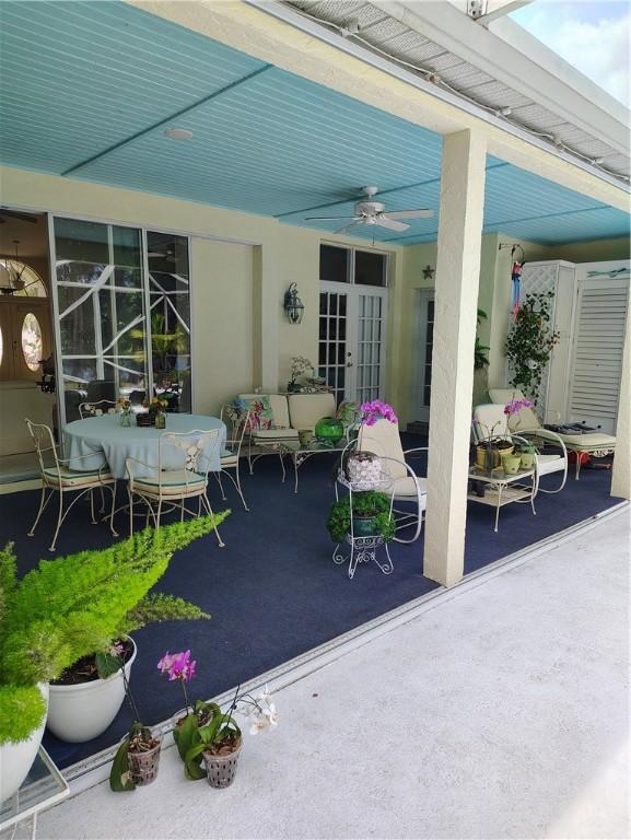 3932 58th Cir, Vero Beach, FL 32966 - view of patio / terrace featuring a ceiling fan, an outdoor living space, and outdoor dining space