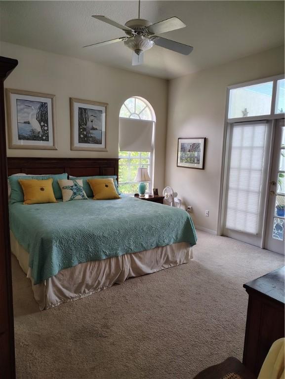 3932 58th Cir, Vero Beach, FL 32966 - carpeted bedroom with a ceiling fan and baseboards